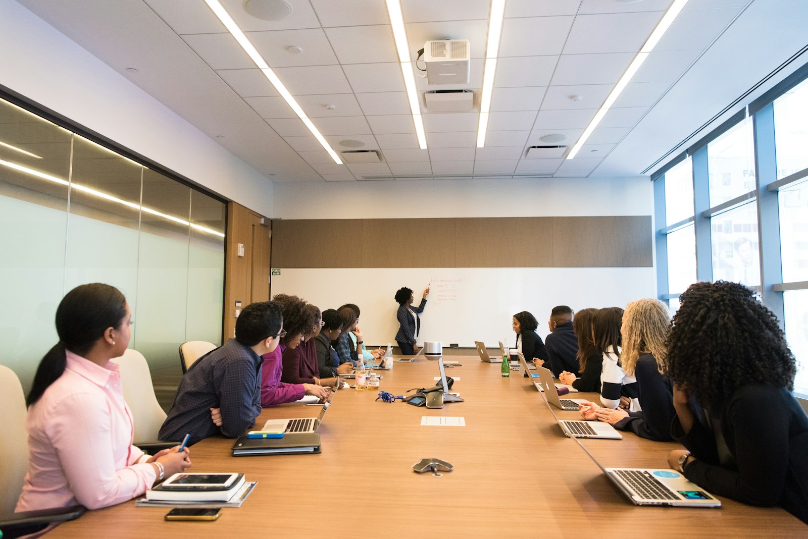 A long committee table in a bright meeting room.