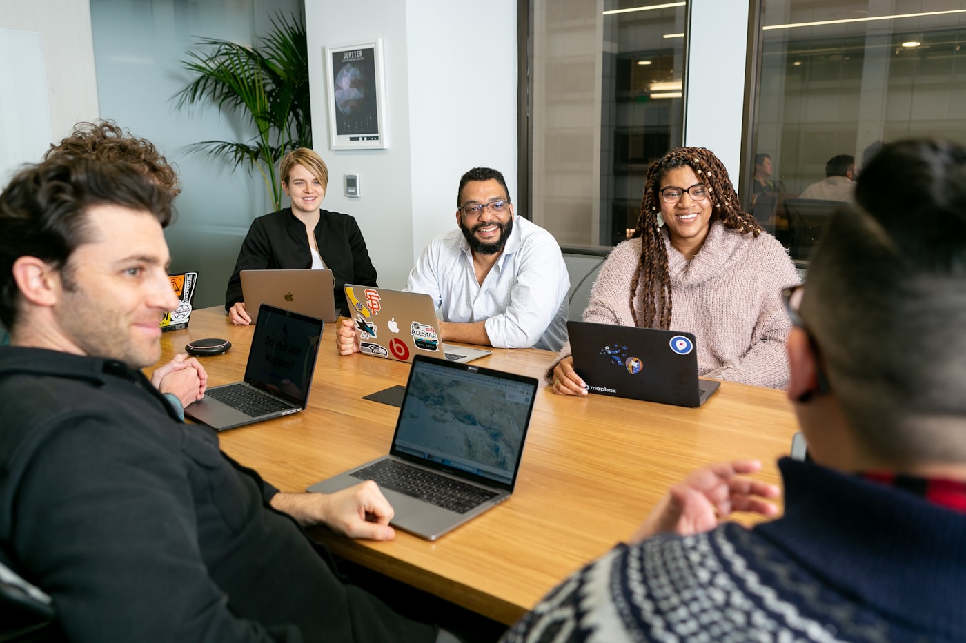 A small team working together around a table.